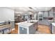 Spacious kitchen with gray cabinets, an island with a marble countertop, and stainless steel appliances at 4002 Joshua Ln, Douglasville, GA 30135
