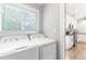 Convenient laundry room with modern washer and dryer units next to kitchen area at 4002 Joshua Ln, Douglasville, GA 30135