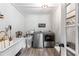 Laundry room with stainless steel washer and dryer, sink, and a door to the backyard at 4002 Joshua Ln, Douglasville, GA 30135