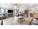 Large living room with fireplace, tv, coffered ceiling, and view into the kitchen at 4002 Joshua Ln, Douglasville, GA 30135