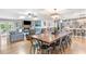 Spacious open-concept living area featuring a large wooden dining table, hardwood floors and fireplace at 4002 Joshua Ln, Douglasville, GA 30135