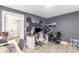Modern home office featuring gray walls, wood floors and a computer setup with a gaming chair at 4002 Joshua Ln, Douglasville, GA 30135