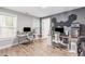 Spacious home office featuring natural light, gray walls, wood floors and dual computer setups at 4002 Joshua Ln, Douglasville, GA 30135