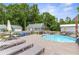 Outdoor pool area featuring an above-ground pool with a deck, seating, and sun loungers at 4002 Joshua Ln, Douglasville, GA 30135