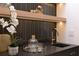 Close up of bar area, featuring black countertop, gold faucet, and modern accents at 1312 Becket Ne Dr, Brookhaven, GA 30319