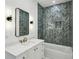 Bathroom features modern gray tilework, dual sconces, a marble countertop vanity, and updated fixtures at 1312 Becket Ne Dr, Brookhaven, GA 30319
