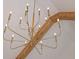 Detailed view of the modern, gold chandelier with wood beam feature at 1312 Becket Ne Dr, Brookhaven, GA 30319