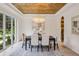 The dining room has a stunning ceiling design, lots of natural light, and an elegant chandelier at 1312 Becket Ne Dr, Brookhaven, GA 30319