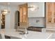 Close up of kitchen island with stainless steel range, marble countertop, and modern pendant lighting at 1312 Becket Ne Dr, Brookhaven, GA 30319