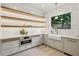 Stylish kitchen with white cabinets, modern lighting, and stainless steel appliances at 1312 Becket Ne Dr, Brookhaven, GA 30319