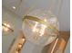 Stylish, spherical glass pendant lighting with brass accents over kitchen island at 1312 Becket Ne Dr, Brookhaven, GA 30319