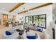 Bright and spacious living room featuring hardwood floors, exposed beams, fireplace, and sliding glass doors to outdoor deck at 1312 Becket Ne Dr, Brookhaven, GA 30319