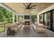 Inviting covered patio with wood ceiling, fireplace, ceiling fan and comfortable seating for relaxing and entertaining at 1312 Becket Ne Dr, Brookhaven, GA 30319