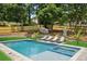 Beautiful backyard pool with sun loungers for relaxation and lush landscaping for added privacy at 1312 Becket Ne Dr, Brookhaven, GA 30319