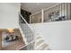 Bright staircase with black metal railings leads to an upper level with a bookcase and seating area overlooking the dining room at 1312 Becket Ne Dr, Brookhaven, GA 30319