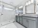 Sleek bathroom with glass-enclosed shower, dual vanity, and modern fixtures at 2140 Colvin Nw Ct, Atlanta, GA 30318