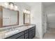 Modern bathroom with granite counters, gray cabinets, and double sinks at 2140 Colvin Nw Ct, Atlanta, GA 30318
