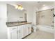 Bright bathroom features a granite countertop, white cabinets, and a shower with tile surround at 2140 Colvin Nw Ct, Atlanta, GA 30318