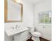 Bathroom with modern sink, toilet, and window with blinds at 2140 Colvin Nw Ct, Atlanta, GA 30318