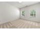 Bright and airy bedroom with neutral carpet, two windows, and ample natural light at 2140 Colvin Nw Ct, Atlanta, GA 30318
