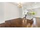 Open dining area with hardwood floors, modern chandelier, and adjacent to a kitchen with island at 2140 Colvin Nw Ct, Atlanta, GA 30318