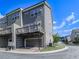 Exterior view of townhome with a deck above the garage, siding, and a manicured lawn at 2140 Colvin Nw Ct, Atlanta, GA 30318