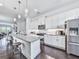 Bright kitchen with white cabinetry, granite counters, an island with seating, and stainless steel appliances at 2140 Colvin Nw Ct, Atlanta, GA 30318