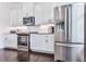 Modern kitchen featuring stainless steel appliances, white cabinets, and granite countertops at 2140 Colvin Nw Ct, Atlanta, GA 30318