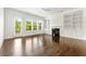 Spacious living room with hardwood floors, a fireplace, built-in shelving, and large windows at 2140 Colvin Nw Ct, Atlanta, GA 30318