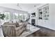 Cozy living room featuring large windows, built-in shelving, a fireplace, and hardwood floors at 2140 Colvin Nw Ct, Atlanta, GA 30318