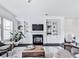 Bright living room offers custom built-ins, a fireplace, large windows, and hardwood flooring at 2140 Colvin Nw Ct, Atlanta, GA 30318