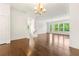 Bright, open living room with hardwood floors, large windows, and a modern chandelier at 2140 Colvin Nw Ct, Atlanta, GA 30318