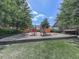 Community playground with colorful equipment, artificial turf and a wooded area for children at 2140 Colvin Nw Ct, Atlanta, GA 30318