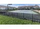 Community tennis courts surrounded by a fence and green landscaping providing a recreational amenity at 2140 Colvin Nw Ct, Atlanta, GA 30318