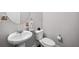 Clean half bathroom featuring a pedestal sink, round mirror and neutral decor at 3116 Quantum Ln, Atlanta, GA 30341