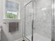 Bathroom featuring tiled shower with glass door, grab bar, shower head, and window at 3116 Quantum Ln, Atlanta, GA 30341