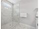 Tiled shower enclosure with glass door and chrome fixtures in bathroom features a window at 3116 Quantum Ln, Atlanta, GA 30341