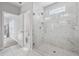 Bathroom featuring a marble tiled walk-in shower with glass enclosure next to the toilet room at 3116 Quantum Ln, Atlanta, GA 30341