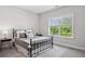 Bedroom with cozy decor including wrought iron bed frame, side tables, and an area rug at 3116 Quantum Ln, Atlanta, GA 30341