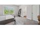Bedroom featuring wrought iron bed frame, side table, and view of bathroom through doorway at 3116 Quantum Ln, Atlanta, GA 30341