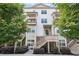 Charming three-story townhome with stone accents, inviting staircase, and lush green landscaping at 3116 Quantum Ln, Atlanta, GA 30341