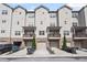 Three-story townhome exterior with private garages, balconies, and manicured landscaping at 3116 Quantum Ln, Atlanta, GA 30341