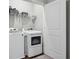 Functional laundry room featuring a washer, dryer, and overhead shelving at 3116 Quantum Ln, Atlanta, GA 30341