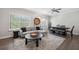 Bright living room with hardwood floors, plush gray sofa, and natural light from large window at 3116 Quantum Ln, Atlanta, GA 30341