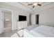Main bedroom with a tray ceiling, adjacent bathroom, and walk-in closet at 3116 Quantum Ln, Atlanta, GA 30341