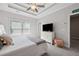 Main bedroom with a tray ceiling, lots of natural light, and a contemporary design at 3116 Quantum Ln, Atlanta, GA 30341