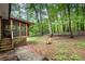 View of brick home featuring a cozy screened-in porch and wooded backyard at 505 Samaritan Dr, Cumming, GA 30040