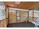 Enclosed porch with brick wall and wooden railing offers a cozy outdoor retreat at 505 Samaritan Dr, Cumming, GA 30040