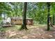 View of brick home with a screened-in porch with partially-fenced backyard at 505 Samaritan Dr, Cumming, GA 30040