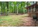 Spacious backyard featuring tall trees, a screened-in porch, and partial fencing at 505 Samaritan Dr, Cumming, GA 30040